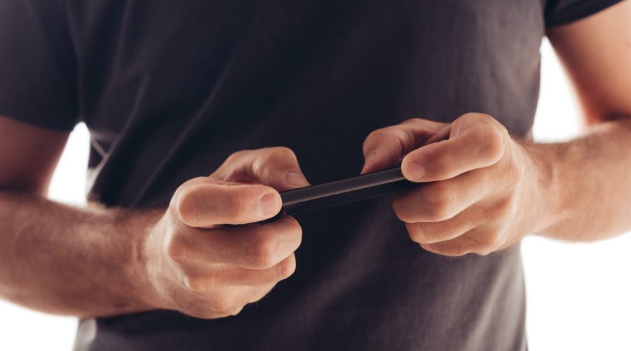 Man playing mobile video game on smartphone